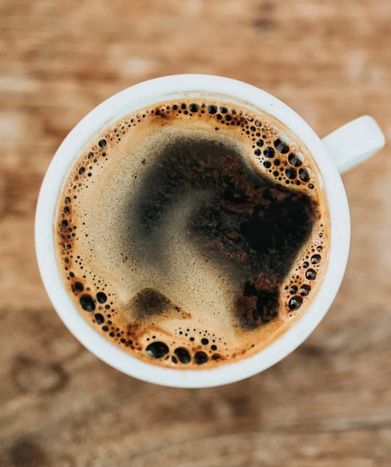 Close-up of a fresh cup of coffee in a mug – EllaVated Coffee Company